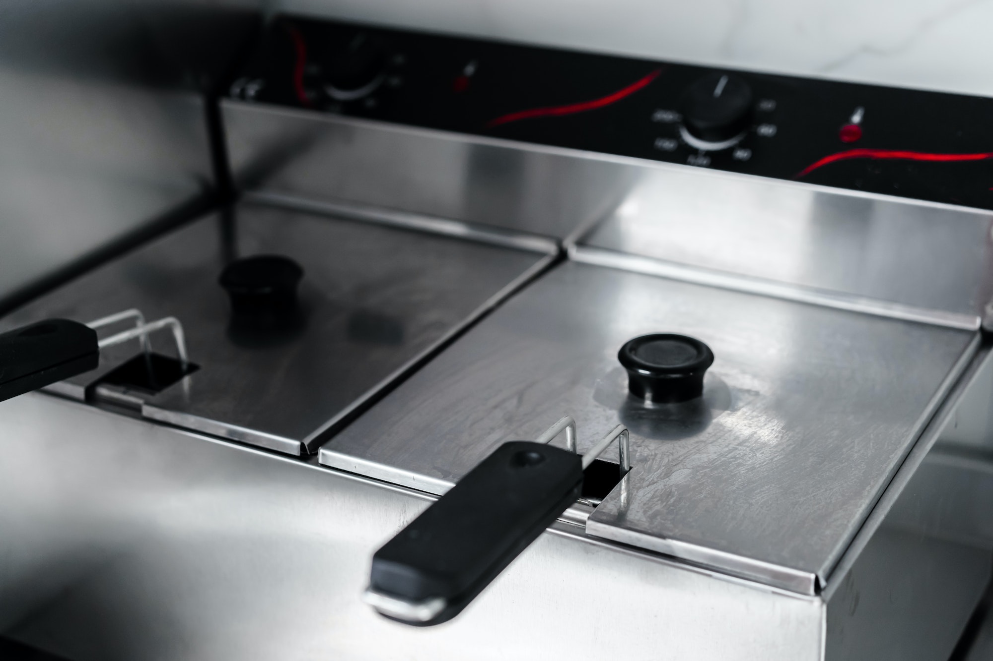 Stainless steel deep fryer machine in professional kitchen